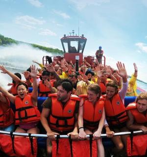 a group of people in a raft in the water