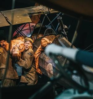 a group of people standing in front of a plane