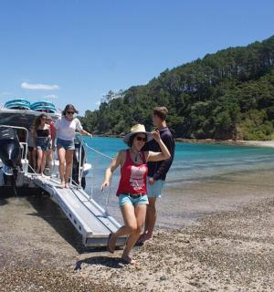 a group of people on a boat on the beach