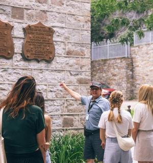 a group of people standing in front of a wall