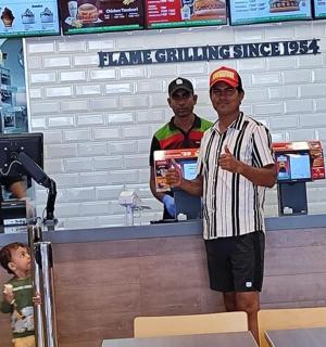 a man standing in front of a counter in a store