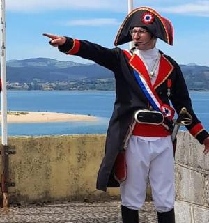 two men in uniform standing next to a wall