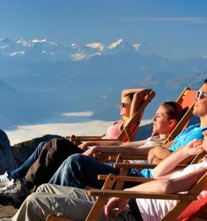a group of people sitting in chairs on the mountain