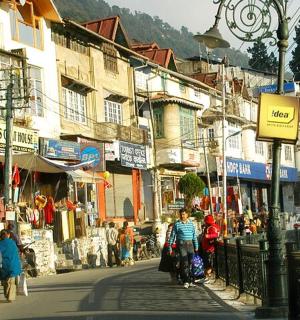 a group of people walking down a street with buildings