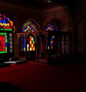 a room with stained glass windows and a bed