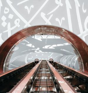 an overhead view of an escalator in a tunnel