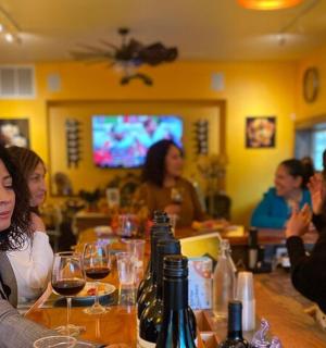 一群人坐在酒吧里，手里拿着酒杯