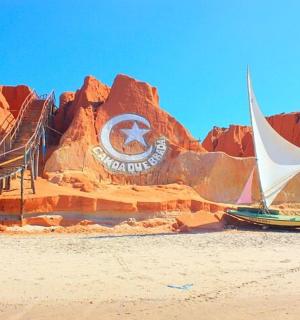 a sand sculpture of a mountain with a sail boat