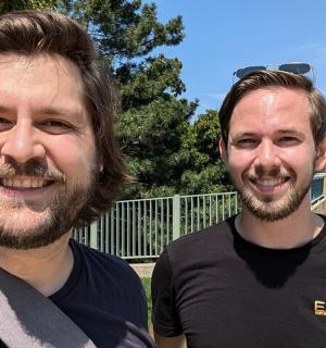 two men are standing next to each other