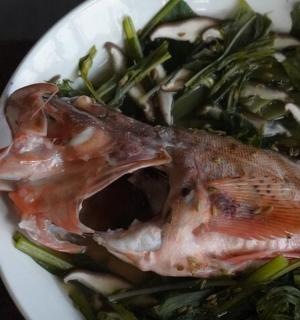 a plate of food with a fish and vegetables