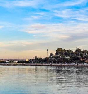 a body of water with buildings in the background
