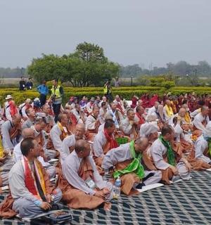 a large crowd of people sitting on the ground