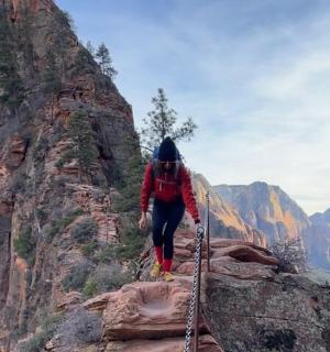 a person is walking on a rock mountain