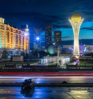 a city skyline at night with a car