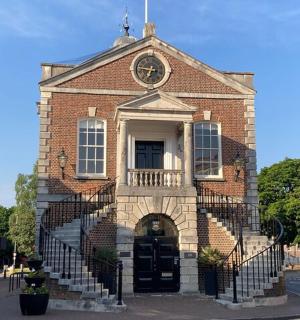 a red brick building with a black door and stairs