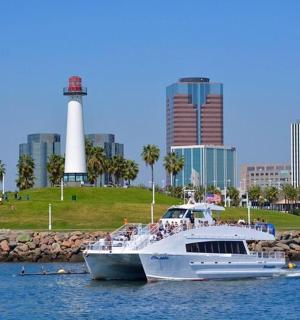 a large boat in the water in front of a city