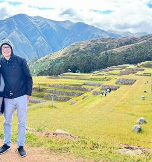 a man and woman standing on top of a mountain