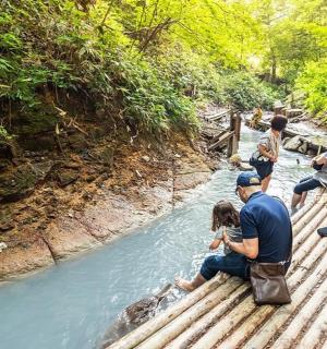 a group of people on a bridge over a river