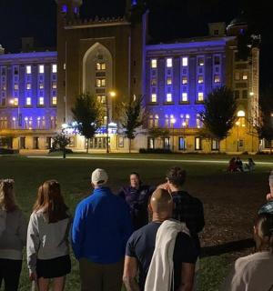 一群人晚上站在一栋建筑前