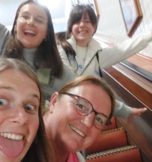 a group of three women riding down an escalator
