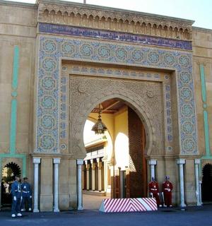 an arch with people standing in front of a building