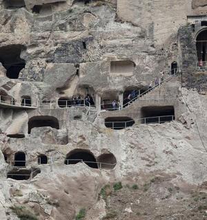 a rock cliff with a building on top of it