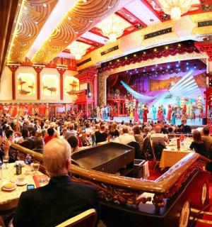 a large crowd of people sitting in a large auditorium