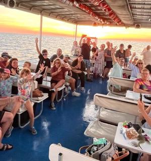 a group of people sitting on a boat