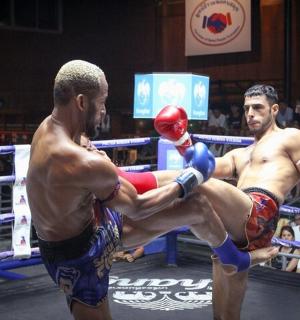 two men are fighting in a boxing match