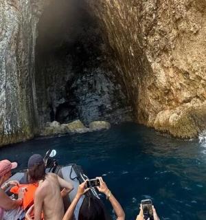 a group of people on a boat going through a cave