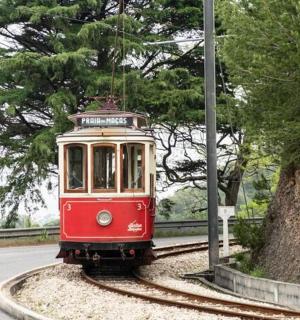 a red and white trolley car on the tracks