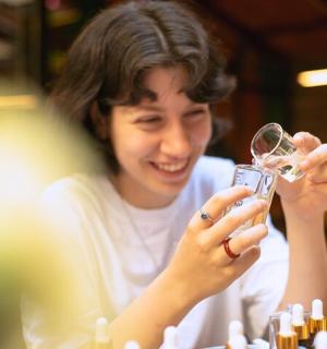 a woman is holding a glass of wine