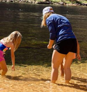 a couple of people and a little girl in the water