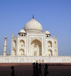 a large white building with two tall domes