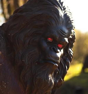 a statue of a black dog with red eyes