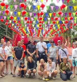 a group of people posing for a picture in front of ailion
