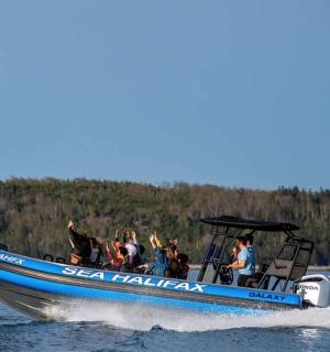 a group of people in a speed boat on the water