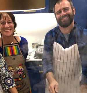 a man and two women standing in a kitchen