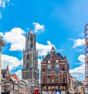 a city street with two tall buildings and a clock tower