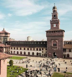 a large building with a clock tower and a courtyard