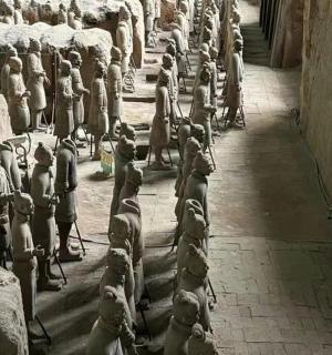 a group of statues are lined up in a room