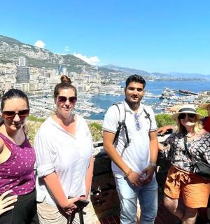 a group of people posing for a picture on a mountain