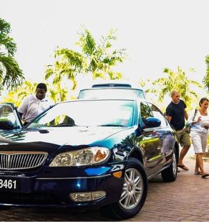 a group of people standing next to a car