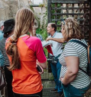 a group of people standing outside of a gate