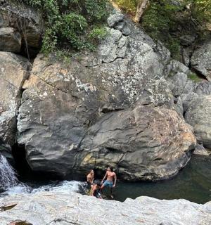 two people are standing in the water in a river