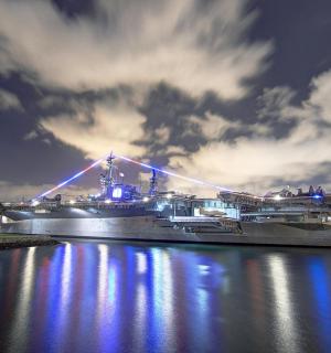 a large ship docked in a river at night
