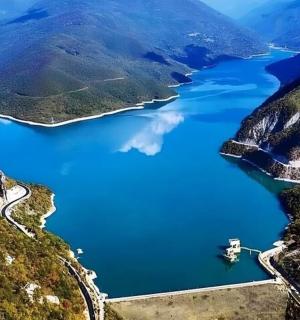 an aerial view of a lake in the mountains