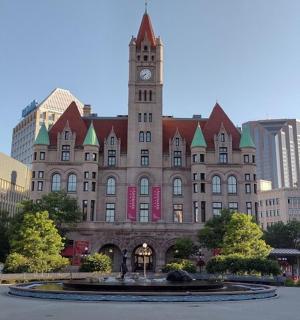 a large building with a clock tower in a city