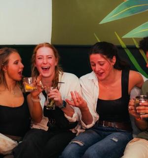 一群人坐在沙发上喝酒