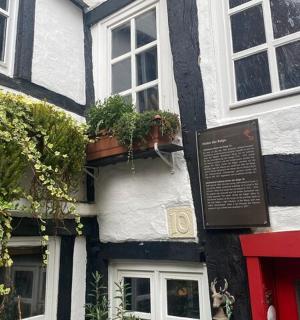 a black and white building with a sign in front of it
